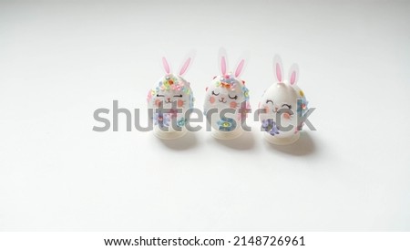 banner. Easter eggs in the form of hares on a white background. Flat styling. Copy the place for the text.