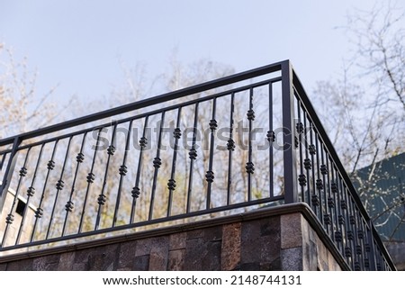 Modern metal railings and handrails in the loft style. The metal is treated with a primer and anti-corrosion paint. Interior design in industrial style. High quality photo