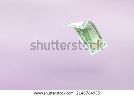Flying one hundred dollars bills on pastel background. US 100 dollar bill close up. Flying money.