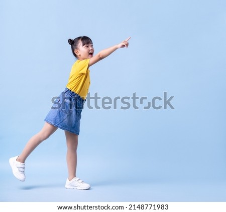 Image of Asian child posing on blue background Royalty-Free Stock Photo #2148771983