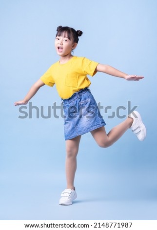 Image of Asian child posing on blue background Royalty-Free Stock Photo #2148771987