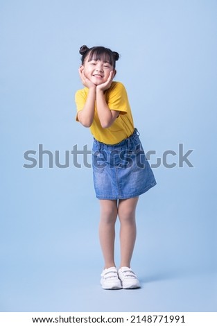Image of Asian child posing on blue background Royalty-Free Stock Photo #2148771991