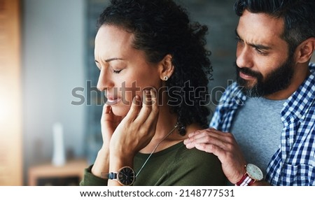 Im here if you need me. Shot of a man comforting his distraught wife at home. Royalty-Free Stock Photo #2148777531
