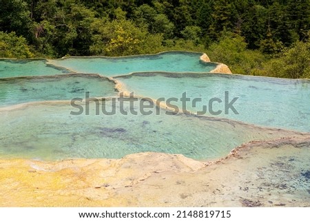 Landscape size picture of the natural pools with turquoise water in Huanglong Scenic Area, Sichuan, China. Close up background image with copy space for text 