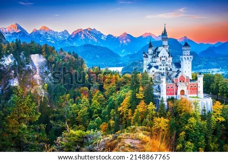 Neuschwanstein Castle, Germany - Bavaria in beautiful autumn colors, fairytale sunrise Bavarian Alps, german travel background.