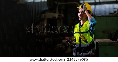 panorama banner. Tired heat and hot. Portrait stress african american female engineer worker wearing safety hard hat helmet at warehouse manufacturing. Metal lathe industrial manufacturing factory.  Royalty-Free Stock Photo #2148876095