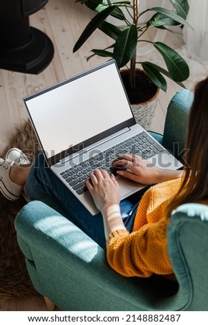 Young woman using laptop screen blank, mock up, work home