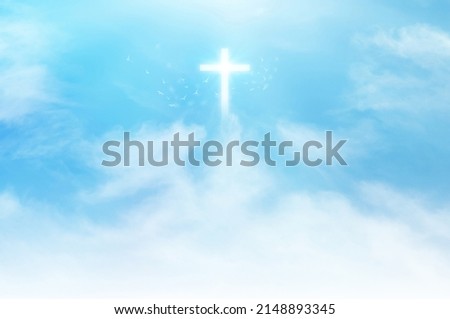 Christian cross appears bright in the sky background and soft clouds. with the light shining as Love. hope and freedom of God Jesus.