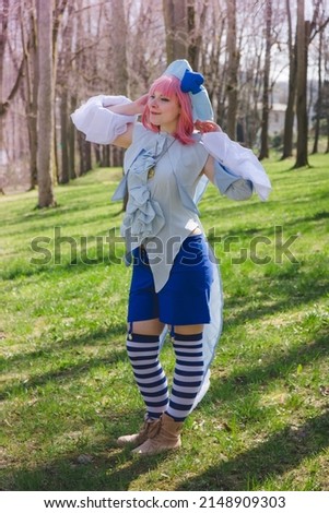 a woman dressed up as an anime character in the forest