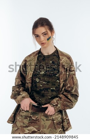 Girl in military uniform. Ukrainian. flag of Ukraine on the face. War in Ukraine. Bucha. on a white background
