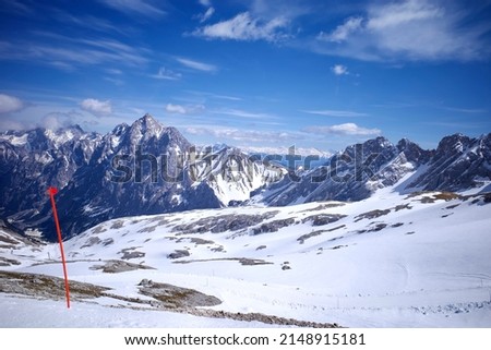 Ski piste on Zugspitze, the only glacier ski area in Germany. The shadow of the ski lift covered on ice ground. 
