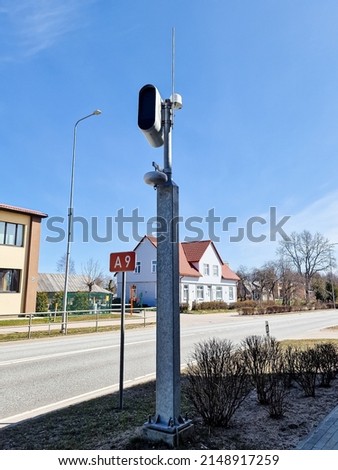 White static speed or safety camera and antenna against a blue sky. Photo radar.