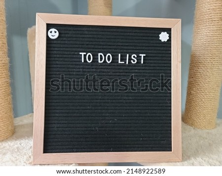 A sign saying to do list. The felt sign has removable letters than can be moved around to make whatever words or saying one wants. 