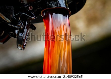 Red disel flowing from a jerry can Royalty-Free Stock Photo #2148932565