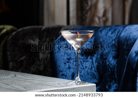 Summer refreshment drinks. Light pink rose cocktail, with rose wine on dark background. With rose flowers. Copy space.