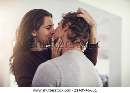 Your kisses make me melt. Shot of a young couple making out in the kitchen. Royalty-Free Stock Photo #2148946681