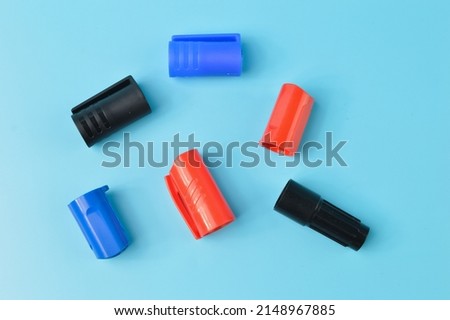Marker pen caps in a row isolated on a blue background Royalty-Free Stock Photo #2148967885