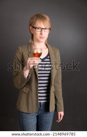 studio portrait of a woman with a glass of wine