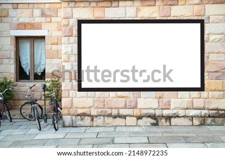 Advertising concept. Billboard on brick aisle walls with clipping path on screen. - can be used for trade shows or promotional posters.