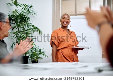 Shes delivered a memorable talk. Shot of a young businesswoman receiving applause from her colleagues during a meeting in an office. Royalty-Free Stock Photo #2148982301