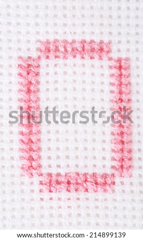 Handmade embroidered letter on white fabric background