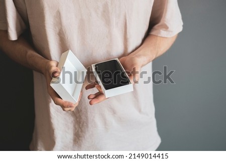 person holds the new smartphone box or case and unpack it, holiday surprise present concept Royalty-Free Stock Photo #2149014415