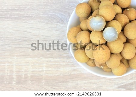 Longan with leaf isolated on wood background full depth of field