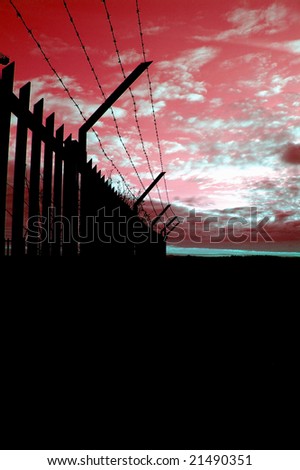 rusty barbed wire against the cloudy sky