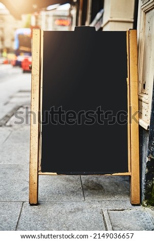 Guess whats on our menu today. Shot of a sidewalk sign with space for you to add your own text.