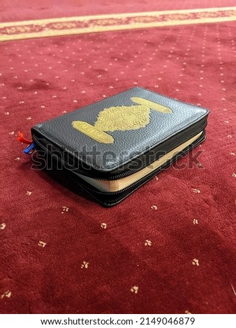 photo of the Koran with a red carpet background