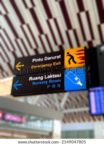 Emergency exit, and Nursery room direction on a airport sign in indonesia