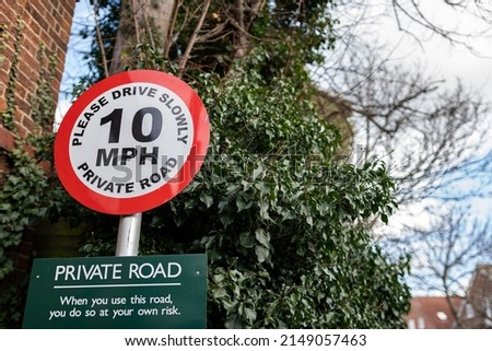 Speed limit sign on a private road asking users to please drive slowly. Pedestrian safety