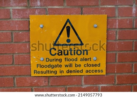Warning sign informing the public that is a risk of a flood, the floodgate will be closed restricting access