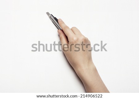 hands with cutter knife isolated white. Royalty-Free Stock Photo #214906522