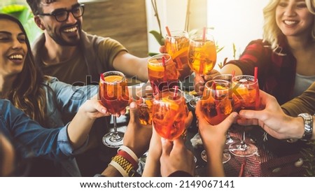 Happy friends cheering drinks glasses in bar restaurant - Young people enjoying happy hour time drinking cocktails - Teenagers celebrating party together - Beverage lifestyle concept Royalty-Free Stock Photo #2149067141