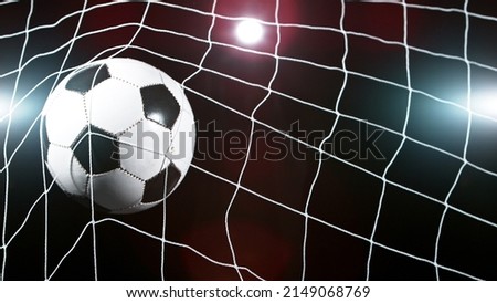 Soccer ball in goal, isolated on black background. Football and soccerr background. Royalty-Free Stock Photo #2149068769