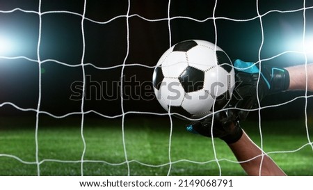Soccer goalkeeper catching the ball, isolated on black background. Football and soccerr background. Royalty-Free Stock Photo #2149068791