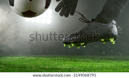 Soccer player goalkeeper kicking ball on grass, detailed shot. Soccer background.