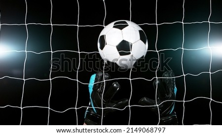 Soccer goalkeeper catching the ball, isolated on black background. Football and soccerr background. Royalty-Free Stock Photo #2149068797