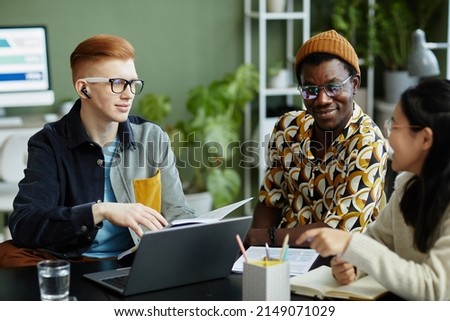 Portrait of young creative team collaborating in business meeting while enjoying work on project together Royalty-Free Stock Photo #2149071029