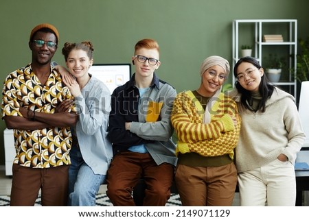 Portrait of diverse creative team in office all looking at camera with cheerful smiles Royalty-Free Stock Photo #2149071129