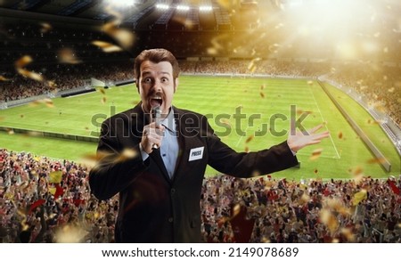 Win. Excited man, professional sport commentator having online broadcast of football match isolated over sport stadium background. Sport news, information. Football fans. Concept of profession Royalty-Free Stock Photo #2149078689