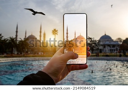 Taking photos of Istanbul, Turkey using a smartphone camera. Blue Mosque on the screen