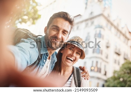 Travel creates meaningful relationships. Shot of a happy couple taking a selfie while out in a foreign country.