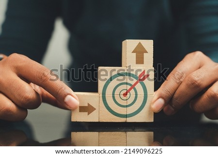 business man holding a wooden block with target icon Various knowledge creation concepts for business success
