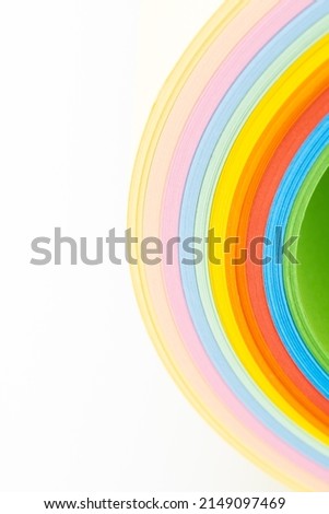 Abstract background with rainbow colored paper, rich shades, close up, white background