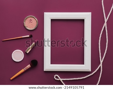 White vertical art frame, make-up products and pearl jewellery on purple background as flatlay design, artwork print or photo album concept