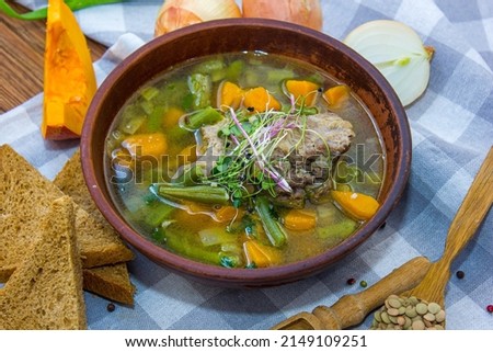 Meat and vegetable soup. Consists of sliced carrots, potatoes, tomatoes, and meat