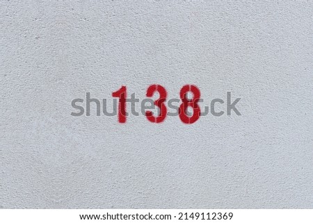 RED Number 138 on the white wall. Spray paint. 
