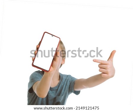 a little boy in a blue T-shirt points with his index finger at the smartphone screen. mockup and layout. space for text and picture.